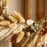Ultra close-up macro of handcrafted modern minimalist dried floral fall wreath with bunny tails and seed pods