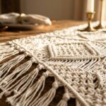 Modern boho cream cotton crochet table runner with knotted fringe on rustic oak dining table