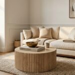 Architectural perspective of small chic living room with cream linen sofa and fluted travertine coffee table
