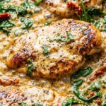 Ultra close-up of creamy garlic butter Tuscan chicken in skillet