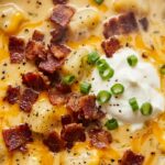 Ultra close-up macro texture of creamy loaded potato soup with melted cheddar cheese, crispy halal beef bacon, and fresh chives