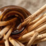 Ultra close-up macro texture of natural botanical reed diffuser with porous rattan reeds in amber glass apothecary bottle
