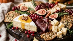 Extreme macro close-up of a lavish Thanksgiving charcuterie board with brie cheese, honey drizzle, halal beef bresaola, pomegranate seeds, and figs